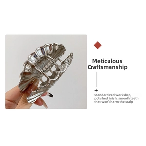 Close-up of a silver polished shell hair claw clip with smooth metal teeth detail