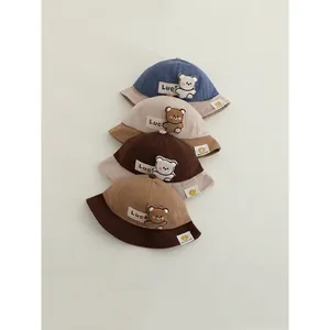 Corduroy baby bucket hats with cute bear patches and Luck labels in four varied colors