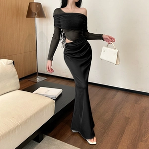 Detail of off-shoulder mesh stitching long sleeve black dress with satin finish skirt