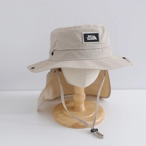 Detail of beige hiking hat featuring a neck protector flap and metal ventilation eyelets