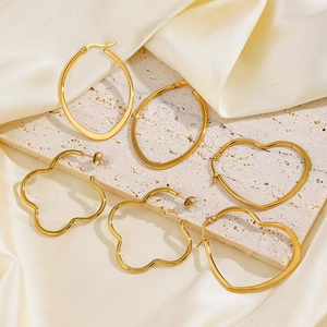 Three pairs of chunky gold stainless steel hoop earrings in heart and oval shapes