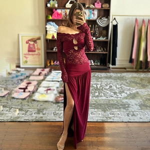 Off-shoulder burgundy lace maxi dress with long sleeves and high slit details