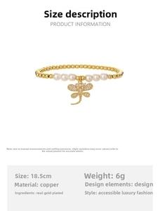 Detailed view of beaded gold bracelet with pearls and a crystal-encrusted dragonfly pendant