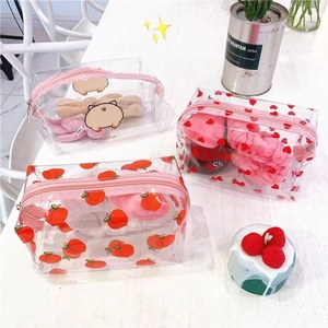 Waterproof clear PVC cosmetic bags with cute fruit prints and pink zippers on marble