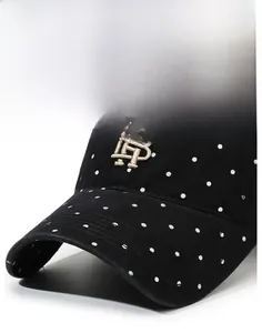 Detail showing the stiff brim and embroidered TB logo on the vintage polka dot baseball cap
