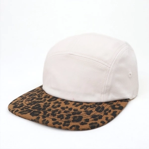 Detail of five-panel camper cap with cream canvas crown and leopard print flat brim