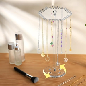 360-degree rotating clear acrylic necklace holder showing jewelry storage on vanity