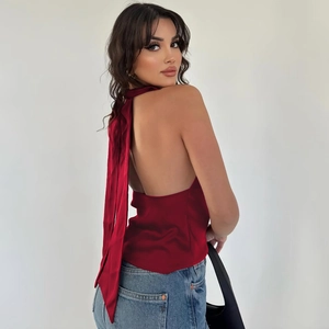 Detail of the backless halter neck design and tie closure on burgundy satin top