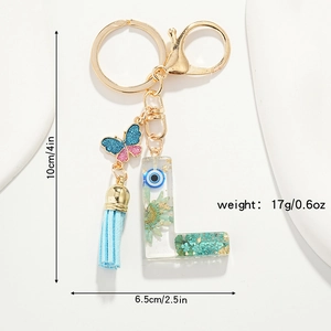 Detail of floral resin letter L keychain with blue butterfly and size specs shown