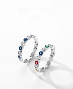 Macro shot of silver evil eye rings with colorful enamel and sparkling zircon detail