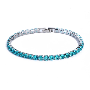 Detail of silver chain bracelet featuring brilliant square cut blue zircon stones