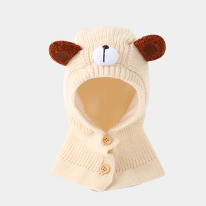 Detail of cream knitted bear balaclava with soft brown ears and wooden button closure