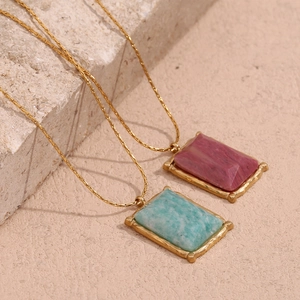 Detailed macro view of 18K gold plated rectangular natural stone pendants on fine chains