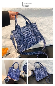 Detail showing blue leopard print canvas texture and detachable strap on crossbody bag
