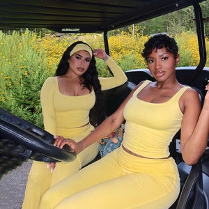 Detail view of stylish yellow two-piece set featuring slim-fit top and high-waisted pants