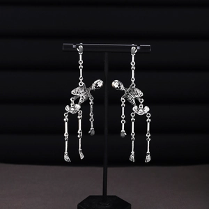 Gothic silver skeleton earrings with blue mesh skirt detail for Halloween jewelry