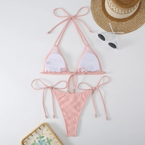 Detail view of pink bikini set featuring textured fabric and decorative silver beads