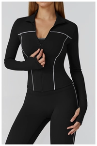 Detail of slim-fit yoga jacket with white contrast stitching and thumbhole cuffs