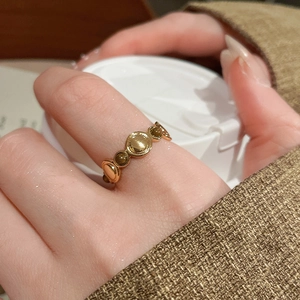 Close-up of 18k gold plated tiger eye ring worn by a model in vintage style