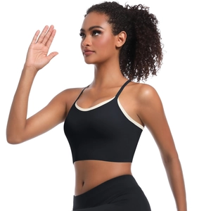 Detail view of high-elastic black sports bra with contrasting beige straps for yoga and fitness