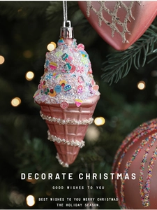Detailed view of a pink ice cream cone Christmas ornament with pearls on a tree