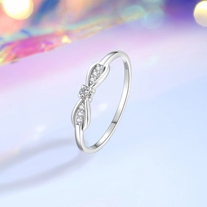Elegant S925 sterling silver bow ring with shimmering cubic zirconia on a dreamy background