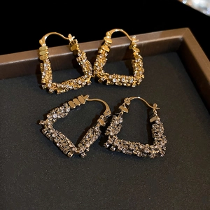 U-shaped geometric metal earrings with micro-set zircon stones in gold and black