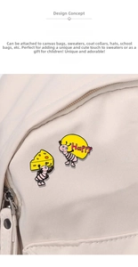 Detailed view of cute cartoon ant enamel pins attached to a beige canvas backpack