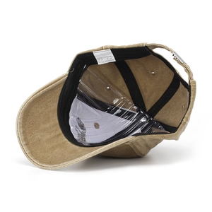 Detail view of khaki cotton baseball cap interior with sweatband and adjustable buckle