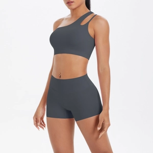 Detailed close-up of dark grey one-shoulder yoga bra and high-waist shorts set