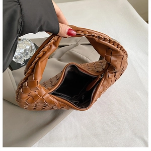 Detailed interior view of a stylish brown woven dumpling handbag for modern women