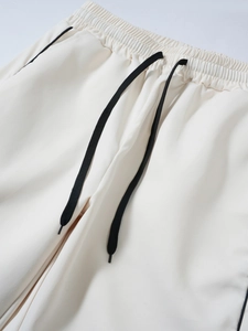 Detail of elastic waistband and black drawstring on off-white techwear cargo pants