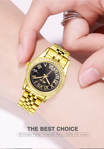Macro view of gold stainless steel watch with black dial and diamond-set bezel detail