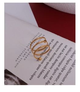 Detail of 18k gold triple spiral rope twist ring with a polished bead accent