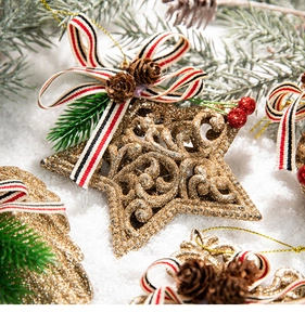 Golden glitter star ornament with pine cones, red berries and striped ribbon bow