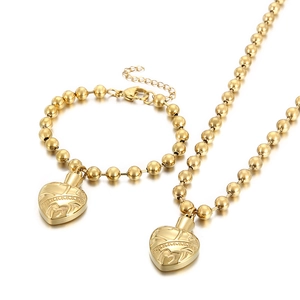 Golden bead chain necklace and bracelet set featuring an engraved heart locket pendant