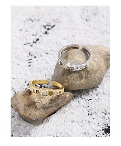 Detail of adjustable S925 silver rings with colorful zircon gems and textured finish