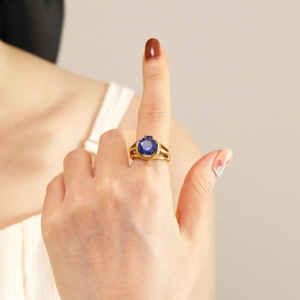 18K gold plated stainless steel ring featuring an oval blue zircon on a hand