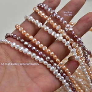 Macro shot of natural 4-5mm baroque freshwater pearls in white, pink, and purple shades