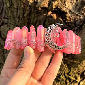 Detail of pink crystal crown featuring silver crescent moon and star charms with wire wrap