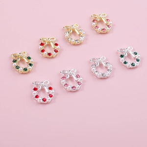 Macro shot of assorted bow Christmas wreath nail charms with pearls and colorful rhinestones