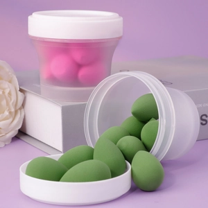 Macro view of teardrop makeup sponges in frosted storage jars with pastel tones