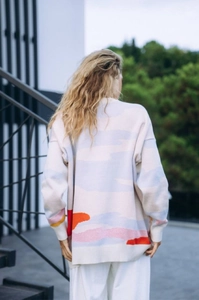 Detailed back view of oversized knit sweater featuring colorful coconut tree jacquard pattern
