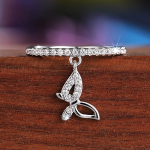Close-up of a silver butterfly pendant ring with sparkling cubic zirconia pavé details