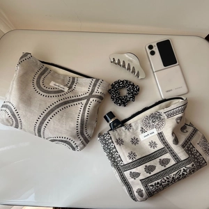 Vintage canvas cosmetic bags with wave and mandala prints, shown with accessories