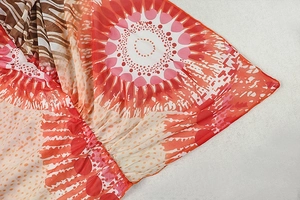 Close-up of vibrant abstract print mesh fabric with side ruching and stitching detail