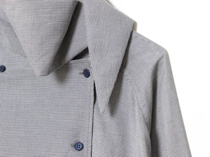 Detail view showing blue houndstooth pattern fabric with buttons on a stylish shirt jacket