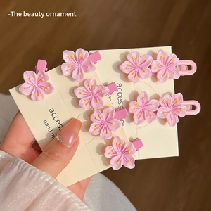 Pink cherry blossom hair clips set with yellow stamens on display card for girls