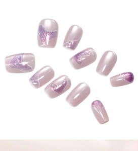 Close-up of pink cat-eye press-on nails with iridescent mermaid tail texture and pearl finish