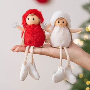 Plush Christmas doll ornaments set in red and white held in hand for holiday tree decor